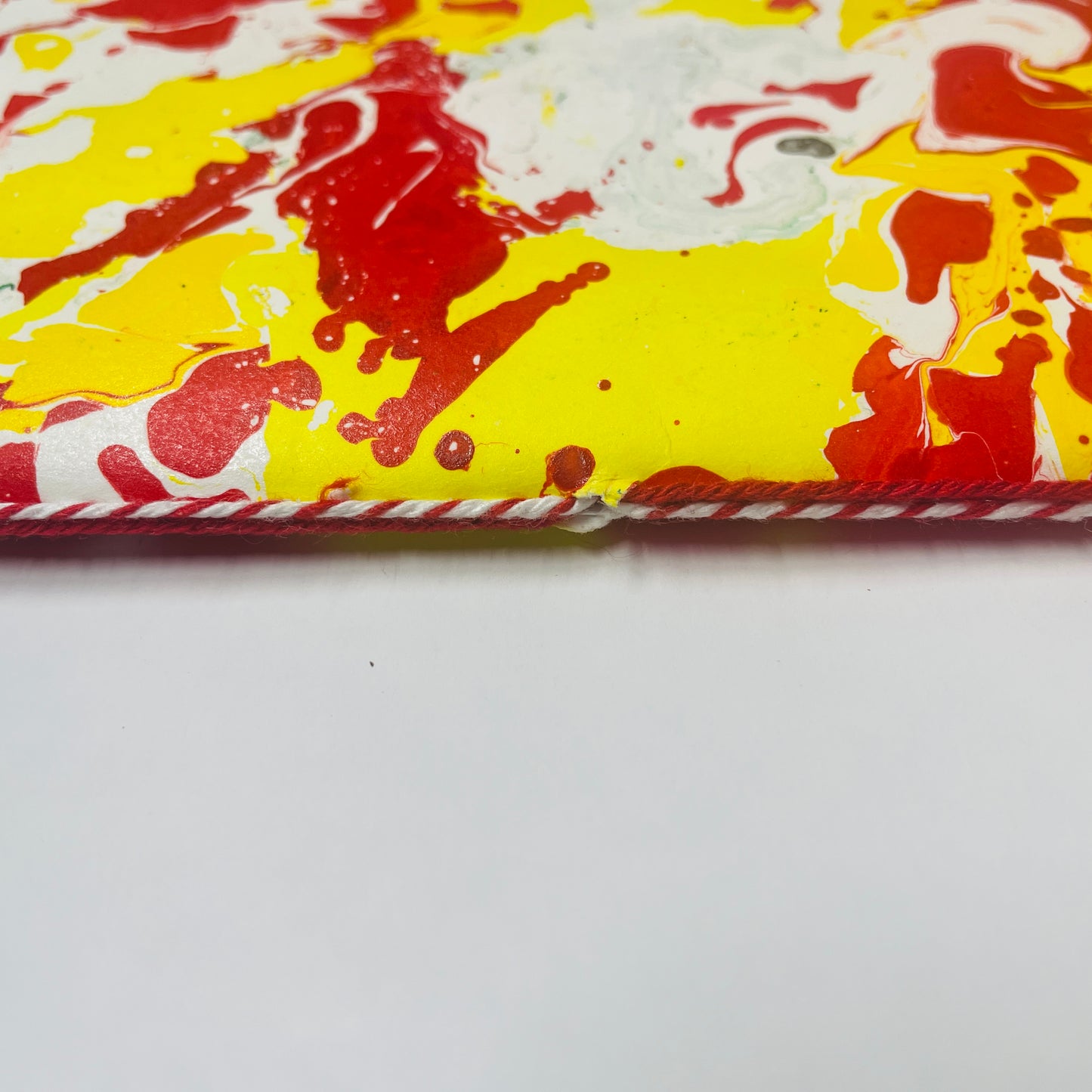 Detailaufnahme der Bindung mit rot-weissem band