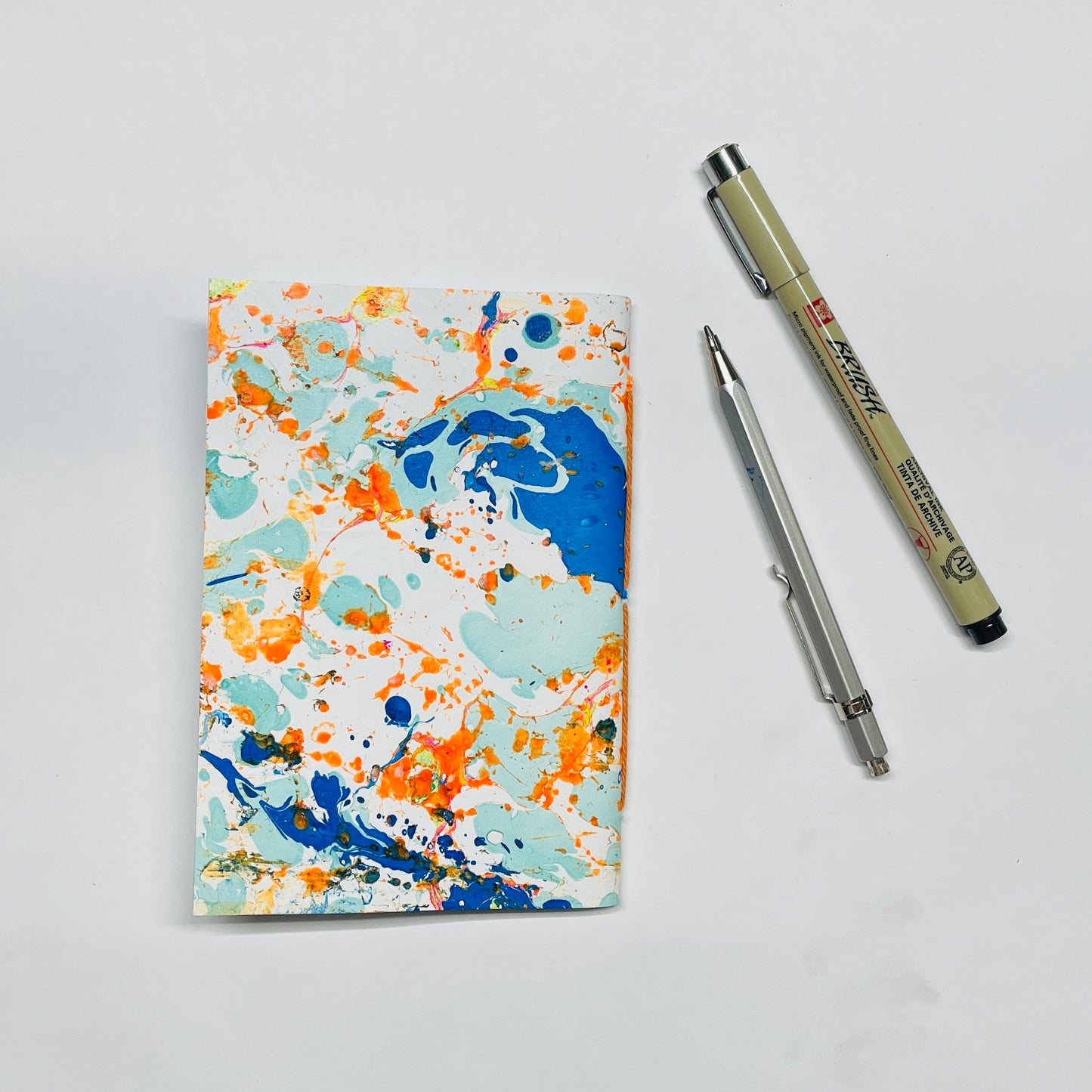 Notizbuch in A6 mit marmoriertem Cover in blau,orange– kreative Papeterie für Planung & Alltag